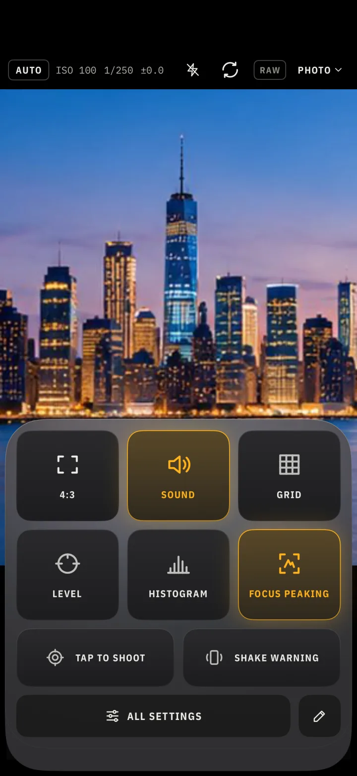 The quick settings tiles over a city skyline at dusk.